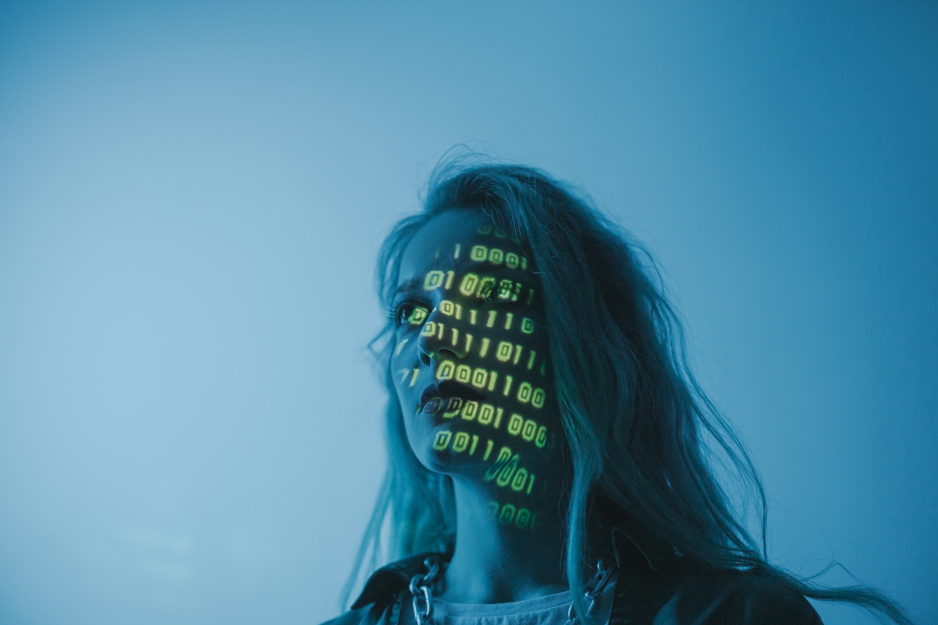 Profile of woman with computer code being projected onto her face