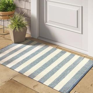 A white and blue doormat from Studio McGee's collection with Target