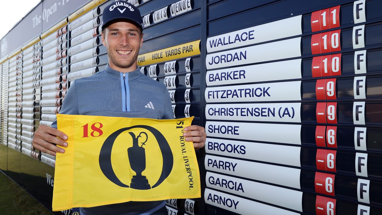 Matthew Jordan holding a flag after he qualified for the 151st Open at Royal Liverpool Golf Club