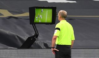 Referee Mike Dean consults the VAR screen before disallowing a goal for Manchester City’s Aymeric Laporte