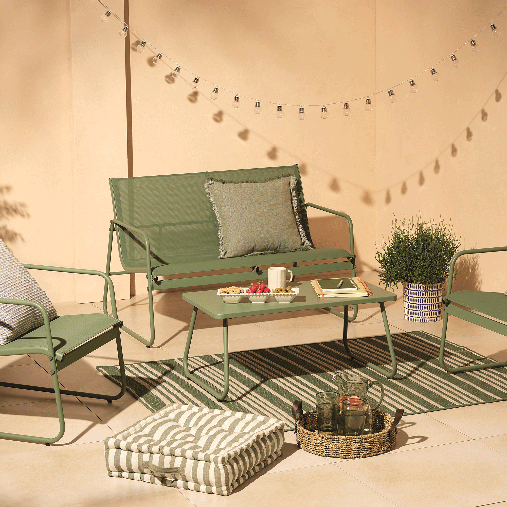 Tesco garden furniture corner sofa with blue and green cushions against a neutral backdrop