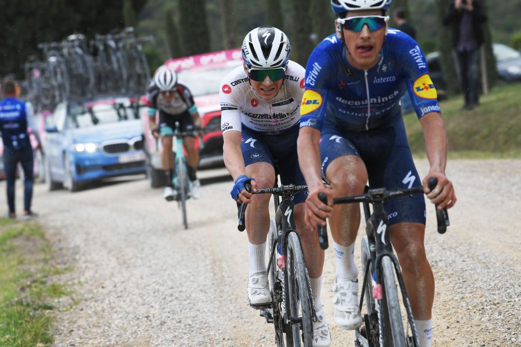 Remco Evenepoel and Joao Almeida (Deceuninck-QuickStep) chase on the dirt roads