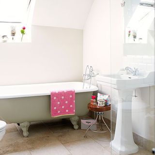 bathroom with white basin and roll top bath