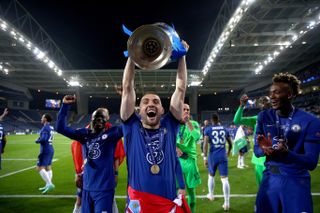 Mateo Kovacic celebrates with the Champions League trophy after Chelsea's win over Manchester City in the 2021 final in Porto.