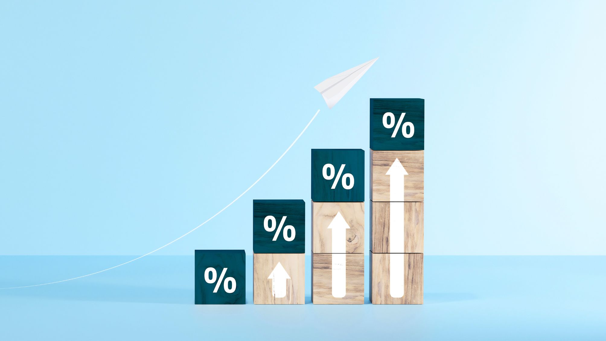 Wooden blocks with percentage signs showing an upward trend