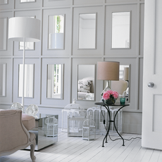 grey wall wooden flooring with lamp and white door