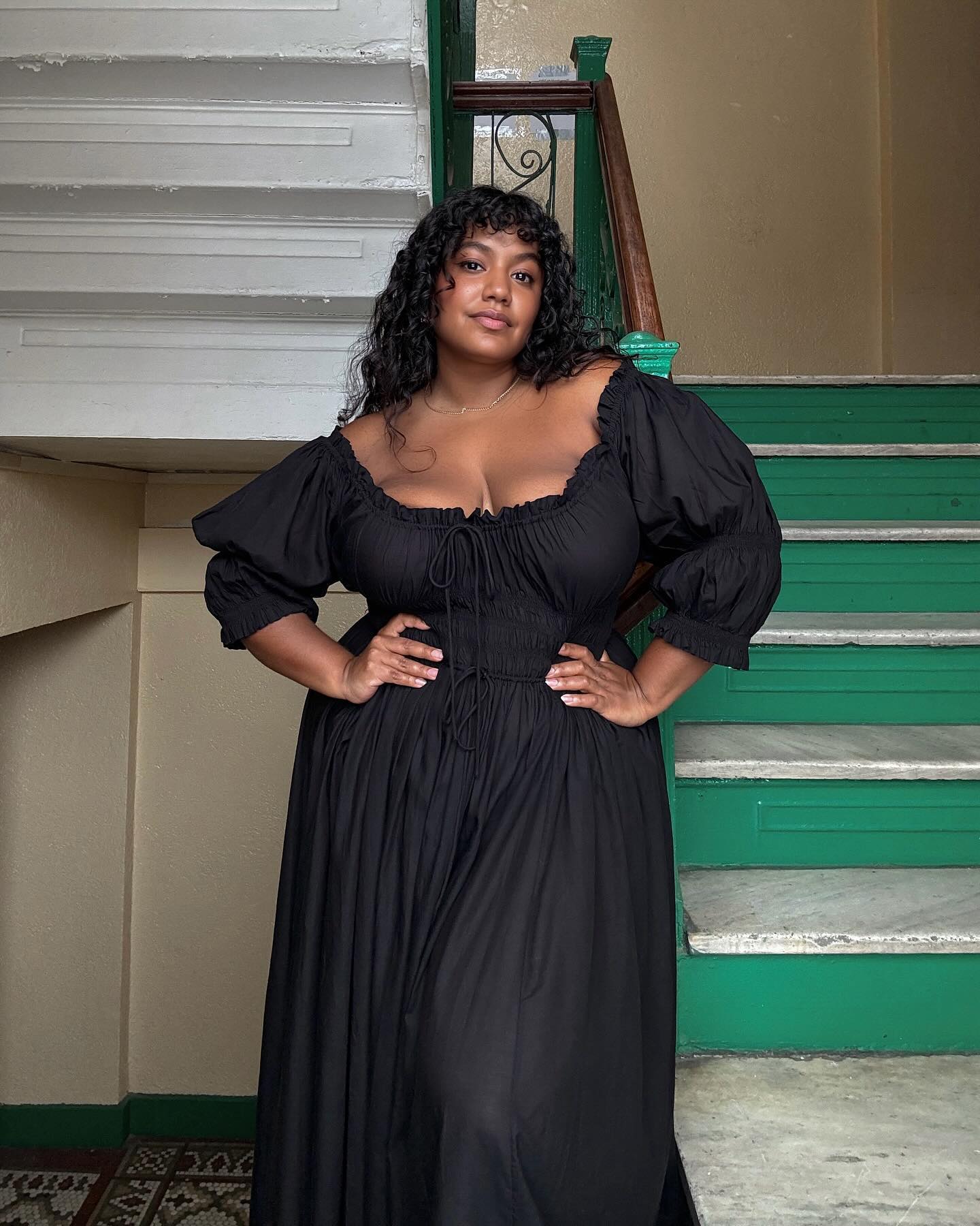 Woman wears black ruched dress