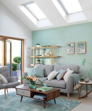 Living room with mint green wall and skylights