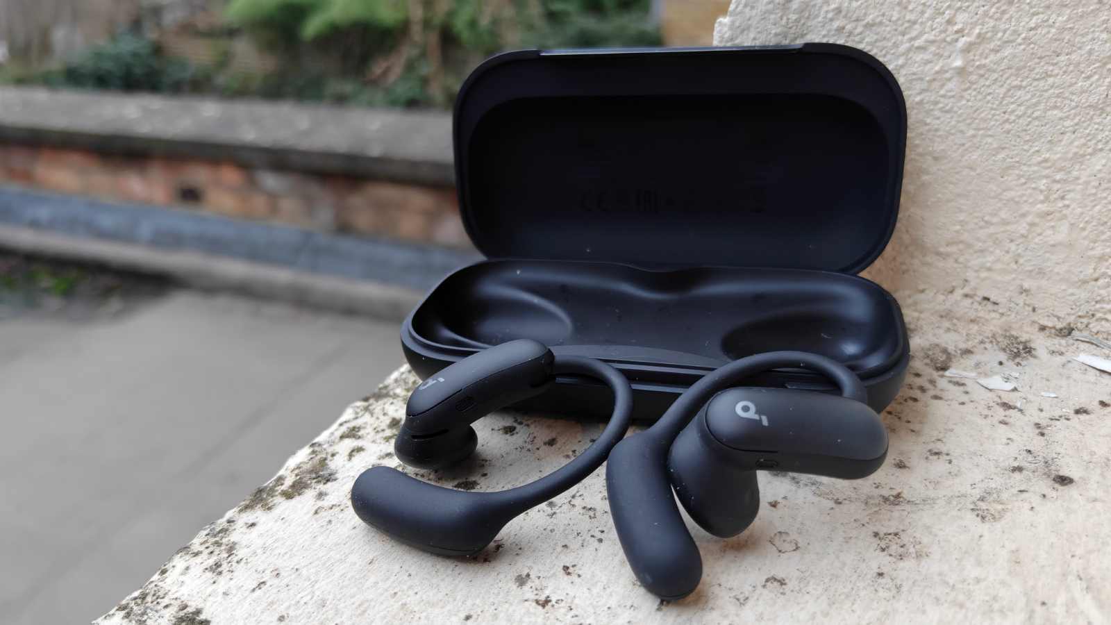 The Soundcore Aerofit 2 Pro next to their case.