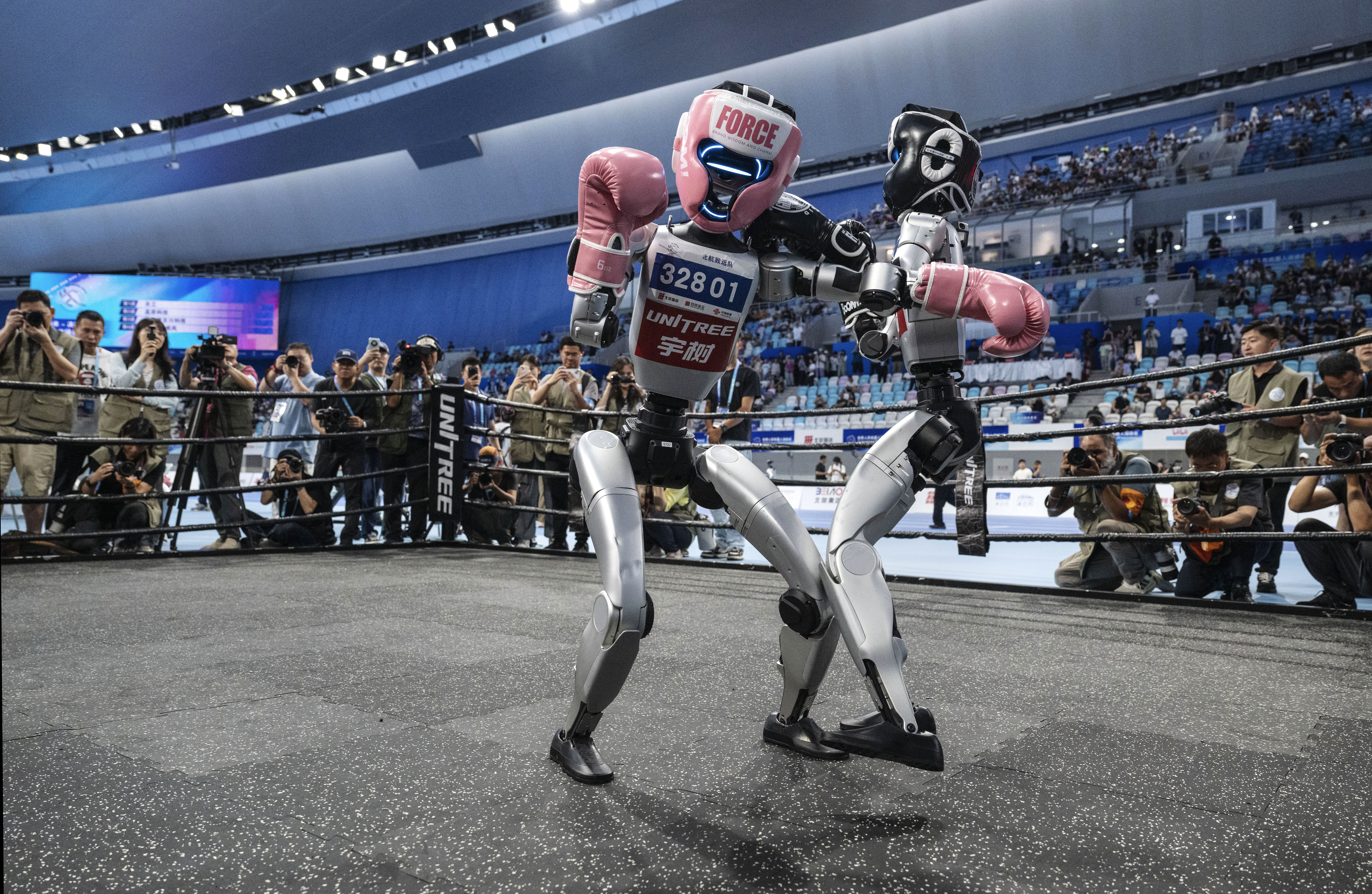 A photograph of robots kickboxing at the  World Humanoid Robot Games.