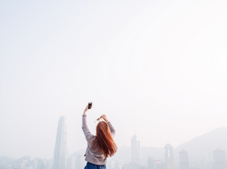 Woman taking a selfie with a mobile phone