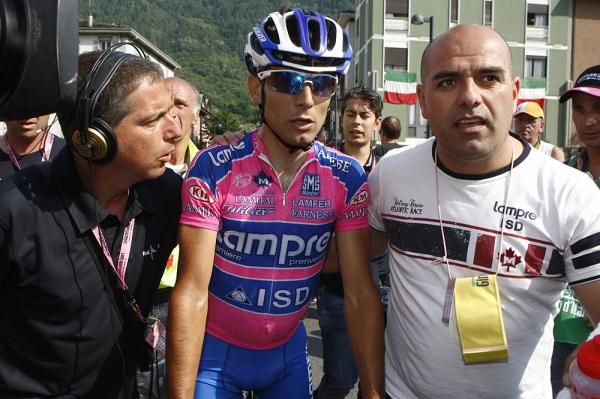 Diego Ulissi is led away from the stage finish