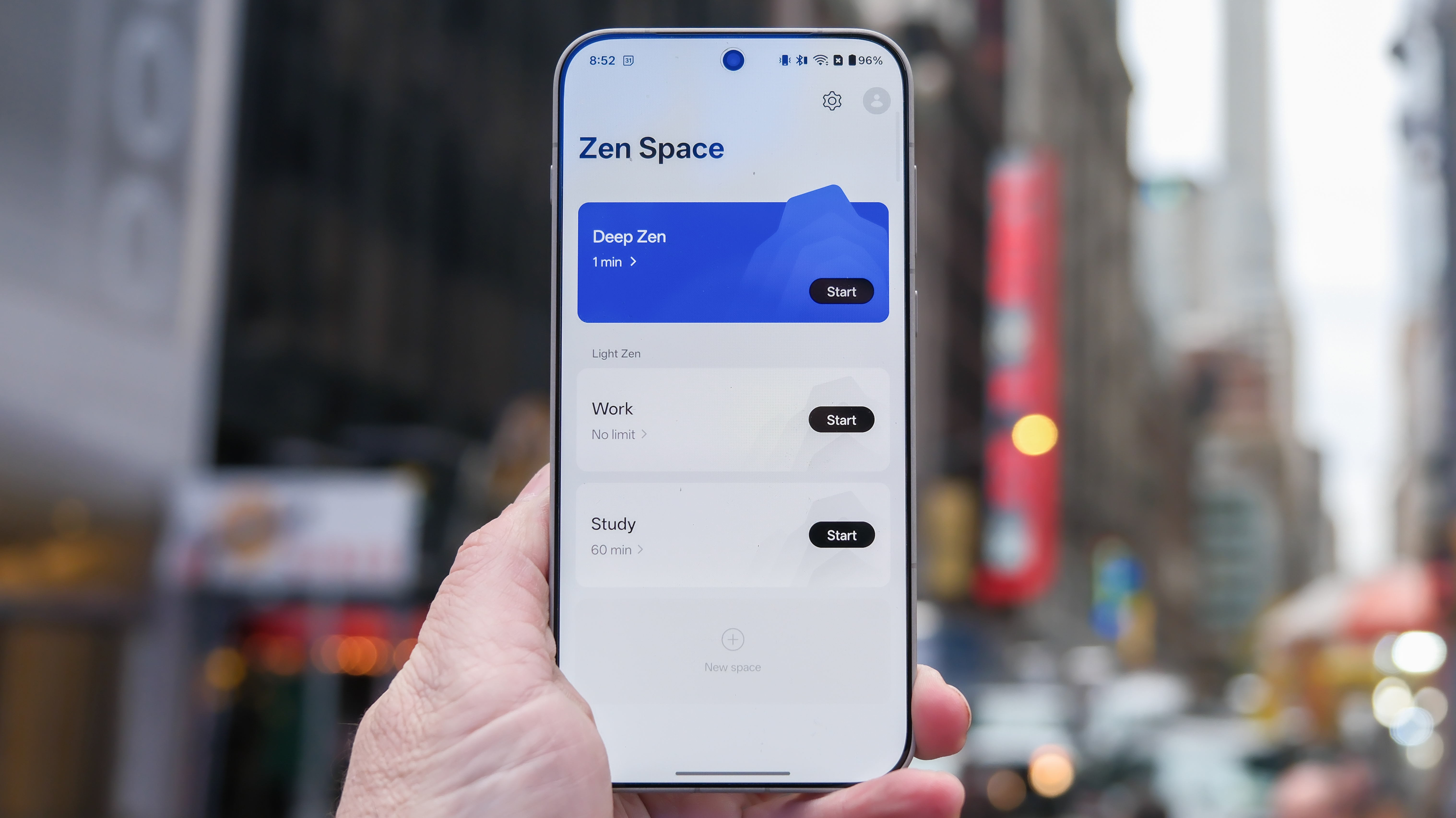 OnePlus 15 in Times Square New York City on the busy street showing the cameras and sides of the phone in addition to home screen panels and Settings menus
