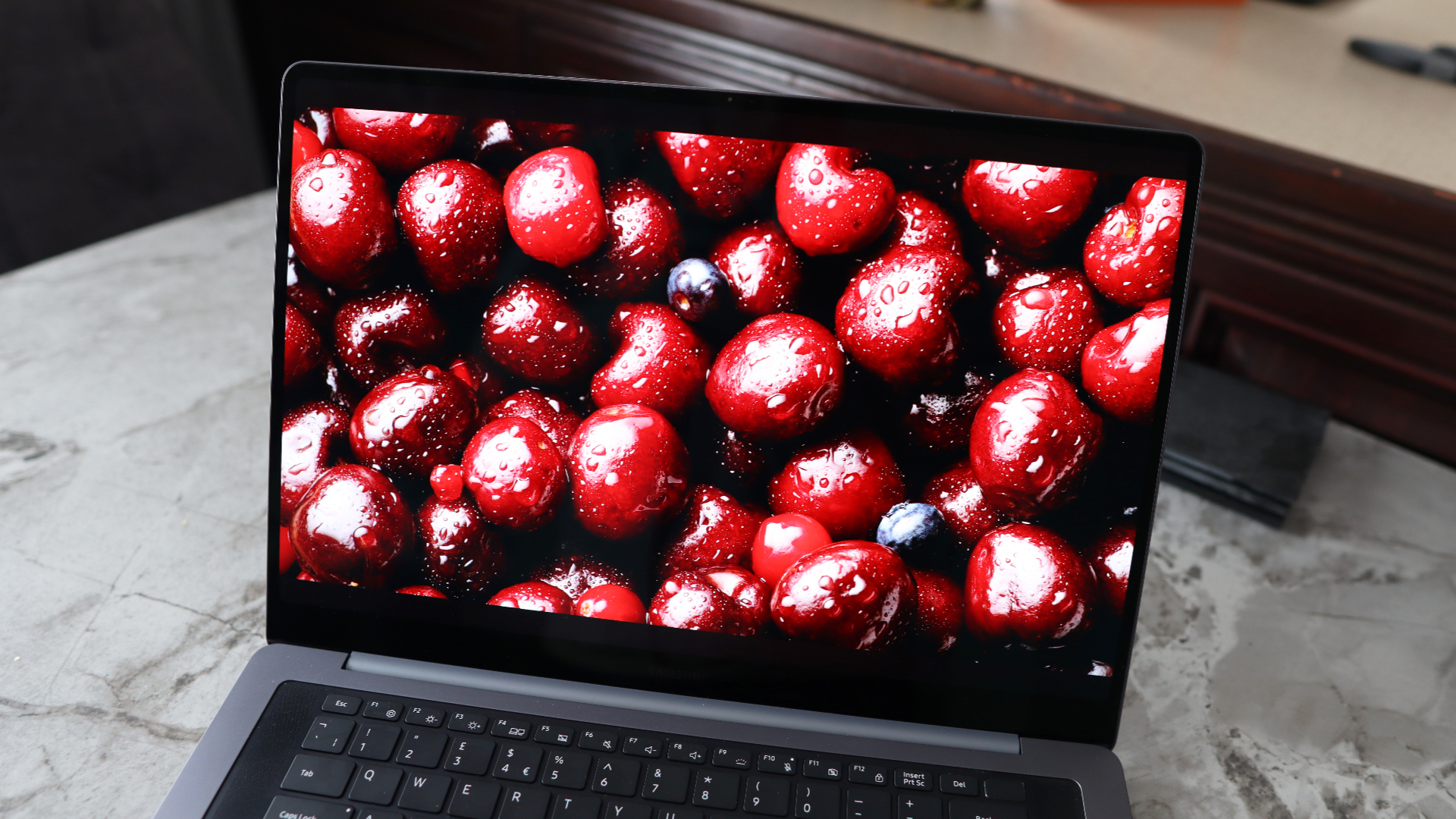 A laptop on a grey worktop surface.