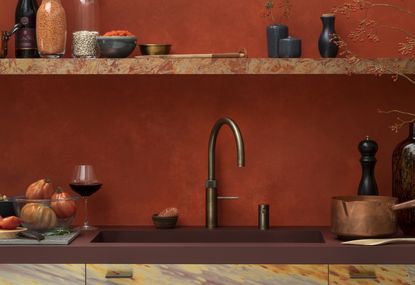 A hot water kitchen tap in a modern kitchen with stone countertop