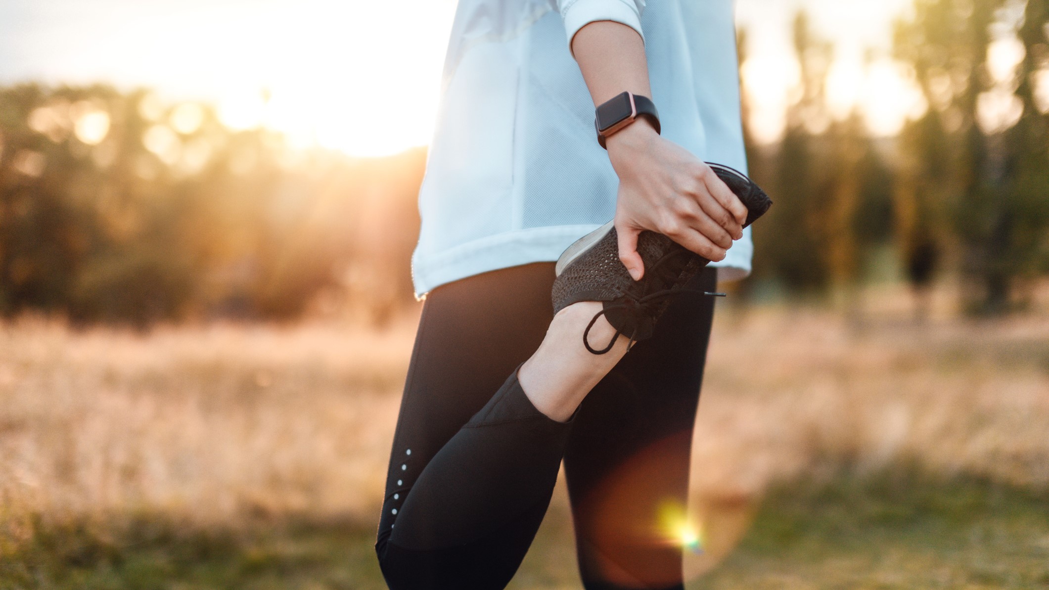 Woman stretching wearing Apple Watch