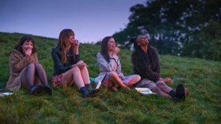 Nell (Marli Siu), Maggie (Emma Appleton), Birdy (Bel Powley), Amara (Aliyah Odoffin) sit together on a grassy hill in Everything I Know About Love