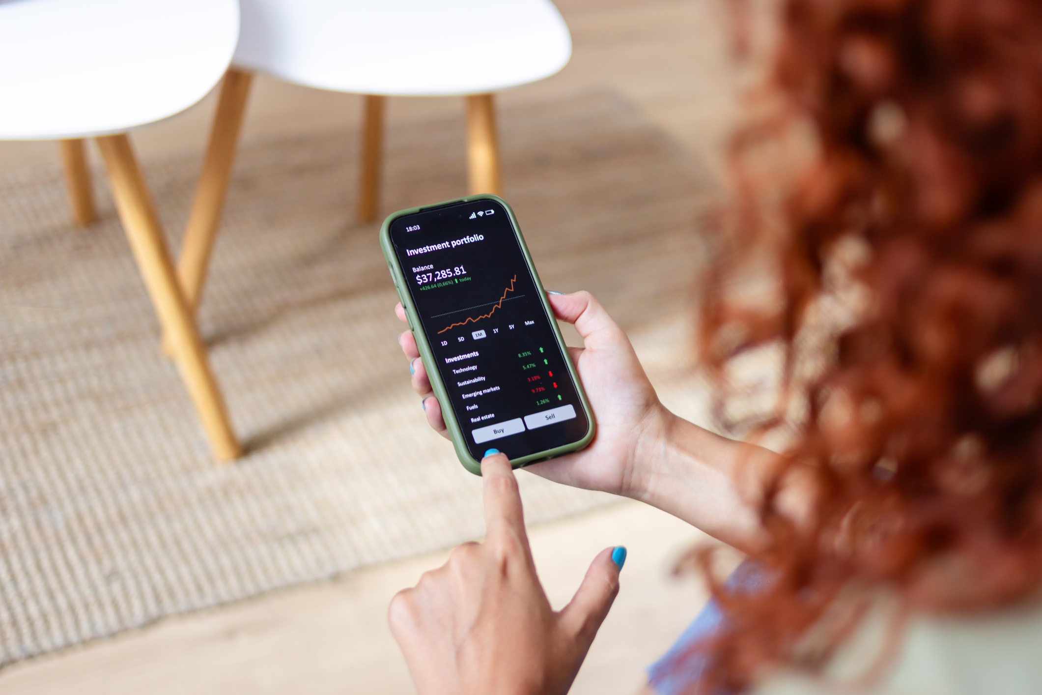 woman analyzing her investment portfolio on an investment platform app