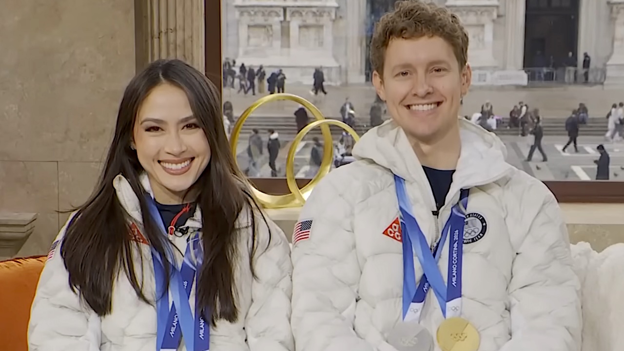 Olympic Ice Dancers Madison Chock and Evan Bates smiling on the Today Show wearing their Olympic medals