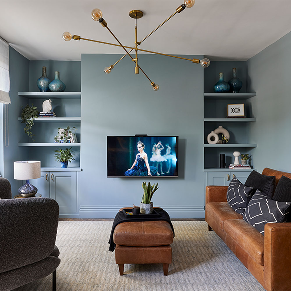 Sophisticated blue living room with TV and brown sofa