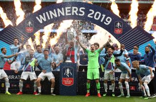 Manchester City’s Vincent Kompany (centre) lifts the FA Cup after a 6-0 victory over Watford