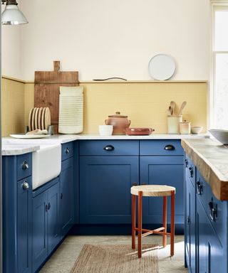 Blue kitchen with yellow painted tiles