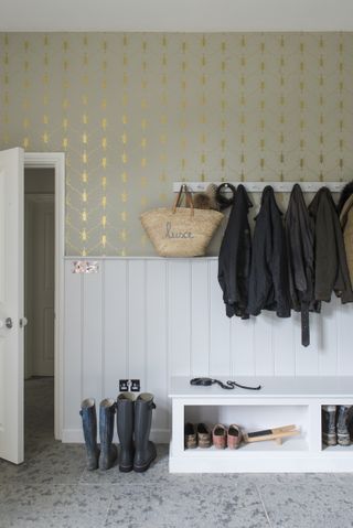 boot room with tiled floor and gold insect wallpaper