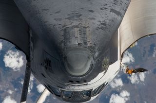 The nose, the forward underside and crew cabin of the space shuttle Endeavour approach first as the STS-134 vehicle prepares to dock with the International Space Station on May 18, 2011 (Flight Day 3). An Expedition 27 crew member took this photo at a dis