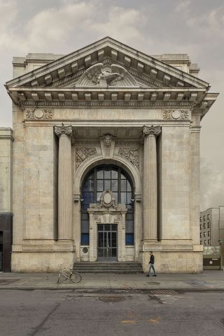 Entrance door with great columns and stone architecture on walls