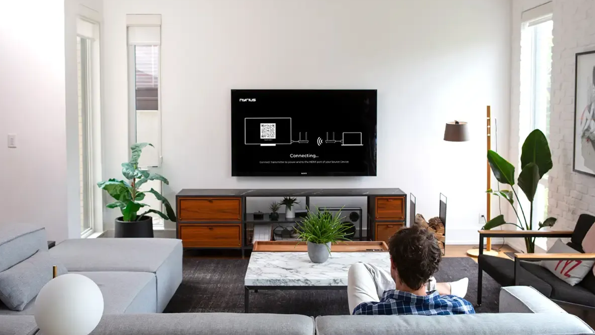 Image of the Nyrius Phoenix Home wireless HDMI being set up in a neutrally decorated room