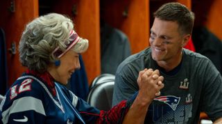 Lily Tomlin and Tom Brady hold hands in a locker room in 80 for Brady