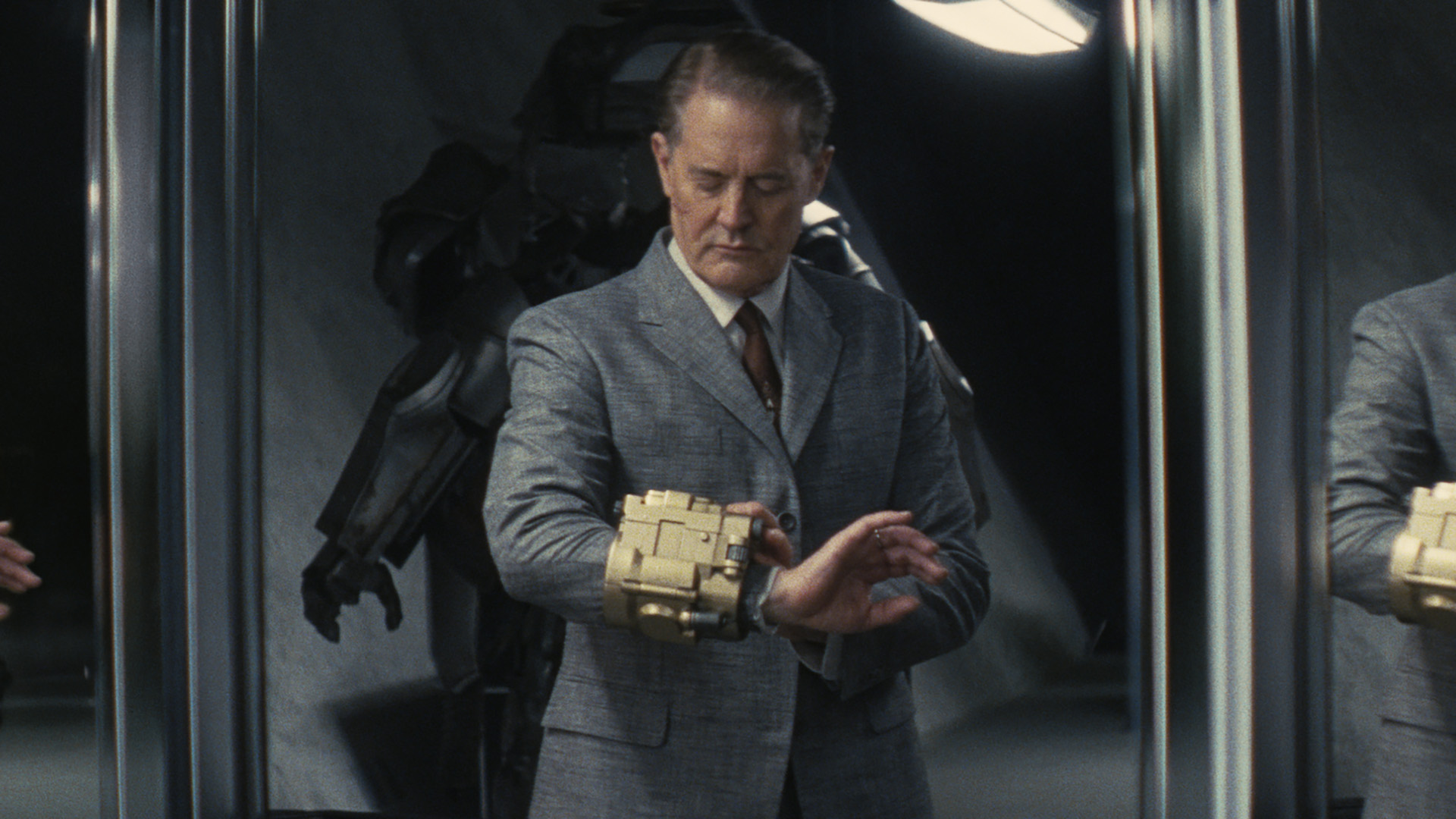 Hank MacLean look at a Pip-Boy on his wrist in Fallout season 2