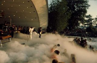 Steve Harley onstage at Crystal Palace Bowl, with dry ice spilling over the laker in front of the stage