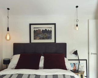 a small bedroom with mismatched naked bulb pendant lighting at bedsides - Philip Lauterbach Photographer