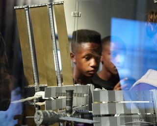 Children Examine International Space Station Model at SpaceFest