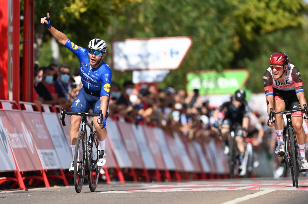 VILLANUEVA DE LA SERENA SPAIN AUGUST 27 Florian Senechal of France and Team Deceuninck QuickStep celebrates winning ahead of Matteo Trentin of Italy and UAE Team Emirates during the 76th Tour of Spain 2021 Stage 13 a 2037km stage from Belmez to Villanueva de la Serena lavuelta LaVuelta21 on August 27 2021 in Villanueva de la Serena Spain Photo by Stuart FranklinGetty Images
