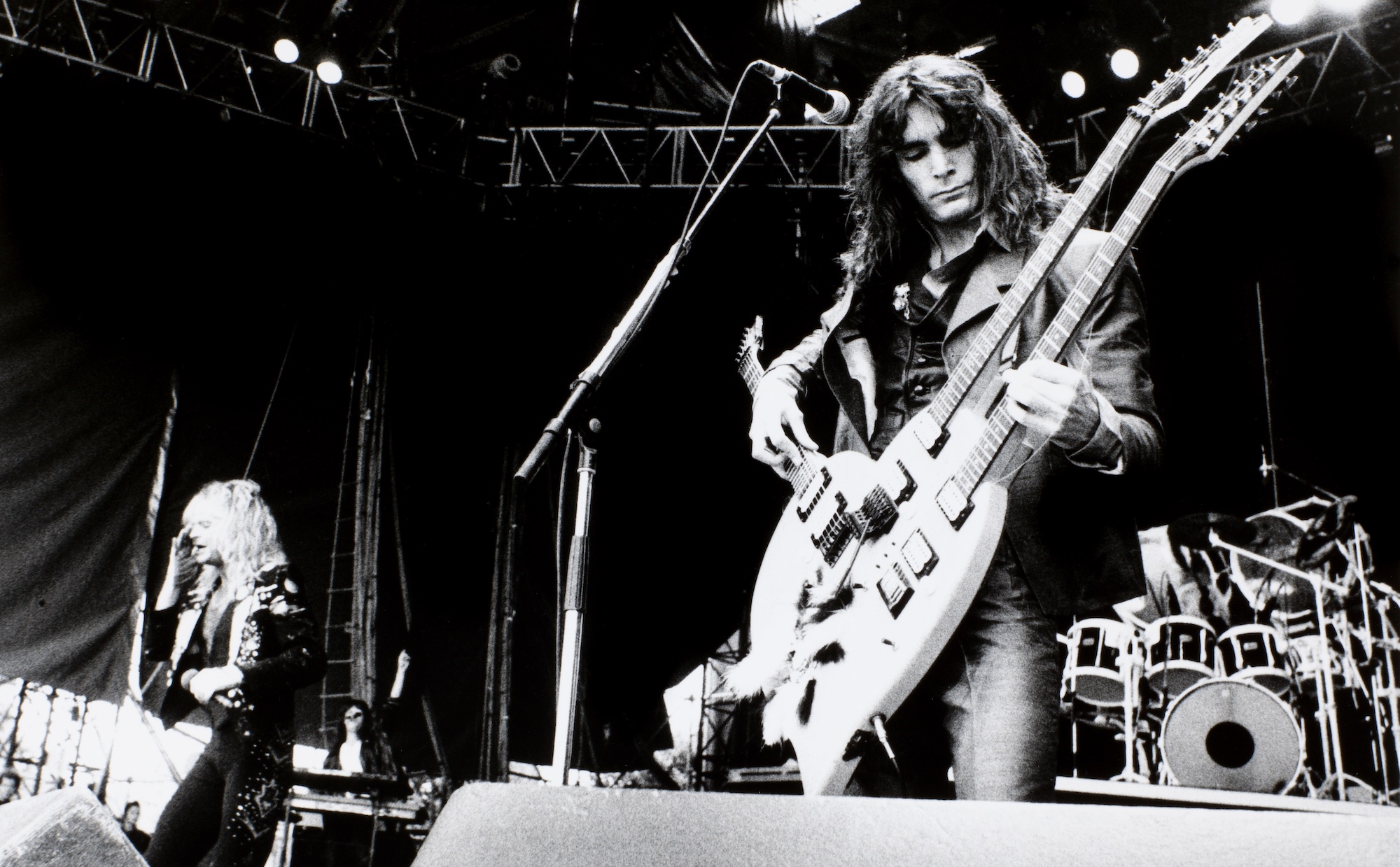 Steve Vai performs on stage, with David Lee Roth to his left, at the Monsters of Rock festival in Tilburg, Netherlands, on April 9, 1988