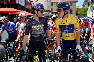Wout van Aert talks to race leader Stefan Küng ahead of stage 2 of the 2023 Tour de Suisse