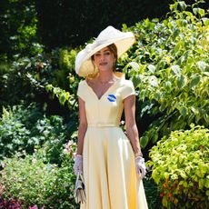 Lydia Millen in a large hat smiling in a garden