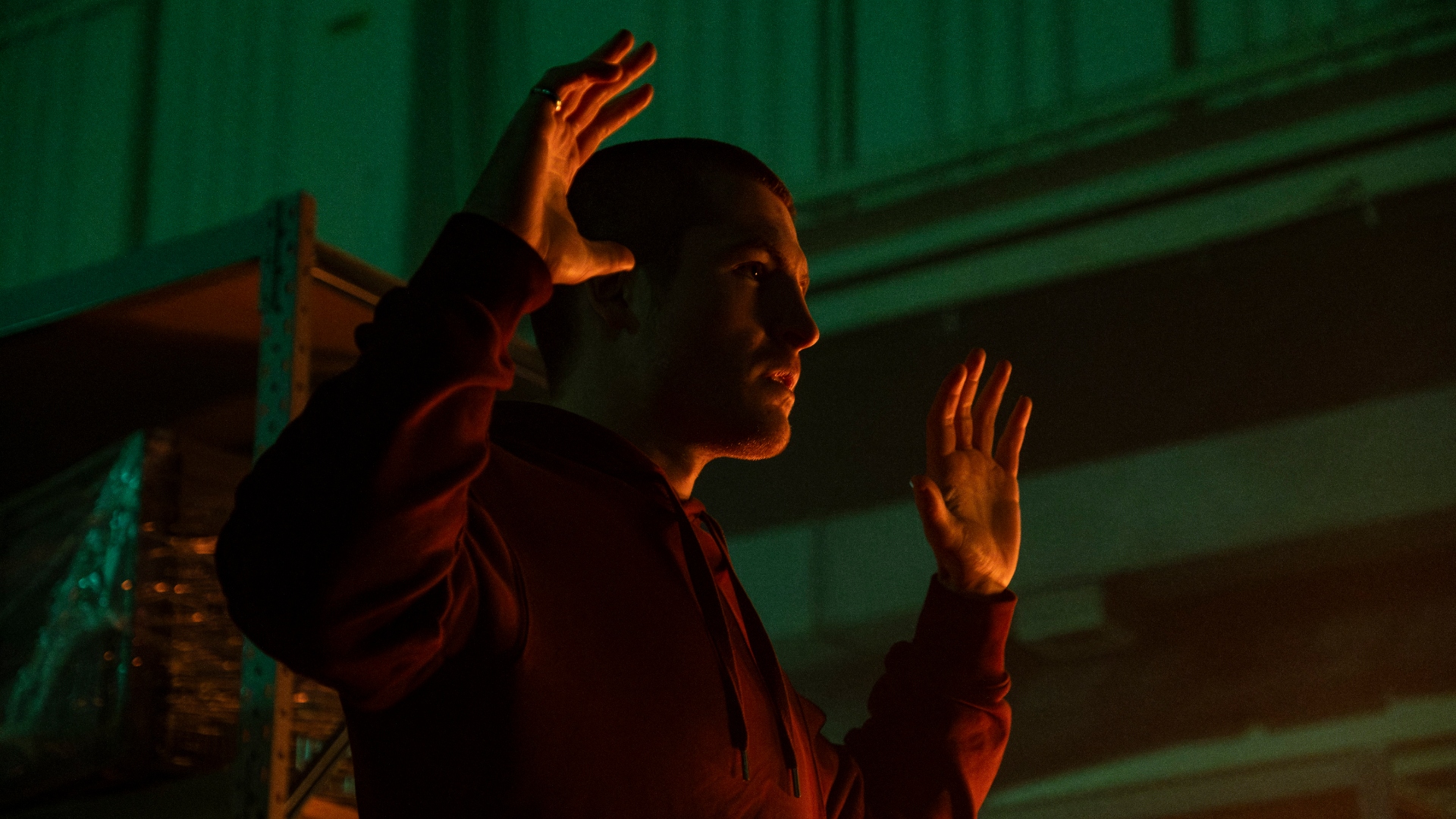 Liam holds his hands up in Code of Silence