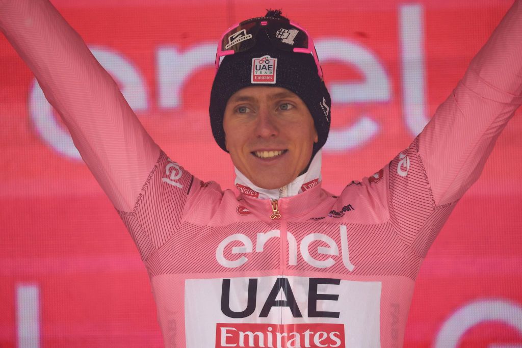 Team UAE's Slovenian rider Tadej Pogacar celebrates the overall leader's pink jersey on the podium after the 16th stage of the 107th Giro d'Italia cycling race, 206km between Livigno and Santa Cristina Val Gardena on May 21, 2024. Team UAE's Slovenian rider Tadej Pogacar wins his 5th stage in the 107th Giro d'Italia cycling race. (Photo by Luca Bettini / AFP)