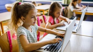 Young girls using laptops