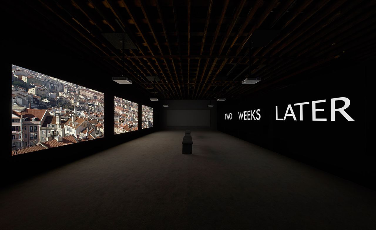 Image of multi-screen film installation with screens on the left and right, screens on the left read &#039;Two weeks later&#039;