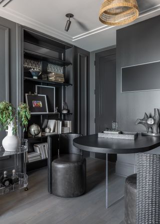 Gray living area with table and bookshelves