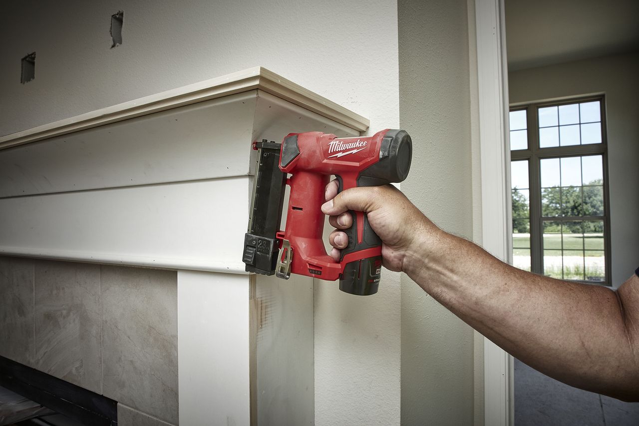 Milwaukee M12 23-Gauge Pin Nailer being used on a mantlepiece