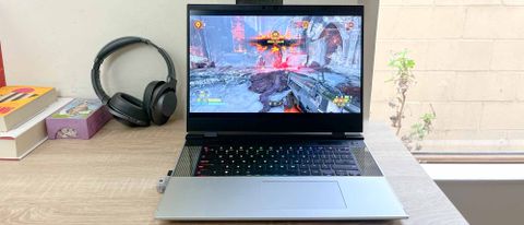 Framework Laptop 16 review unit on table with Doom Eternal playing
