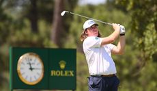 Neal Shipley hits an iron shot and watches it flight