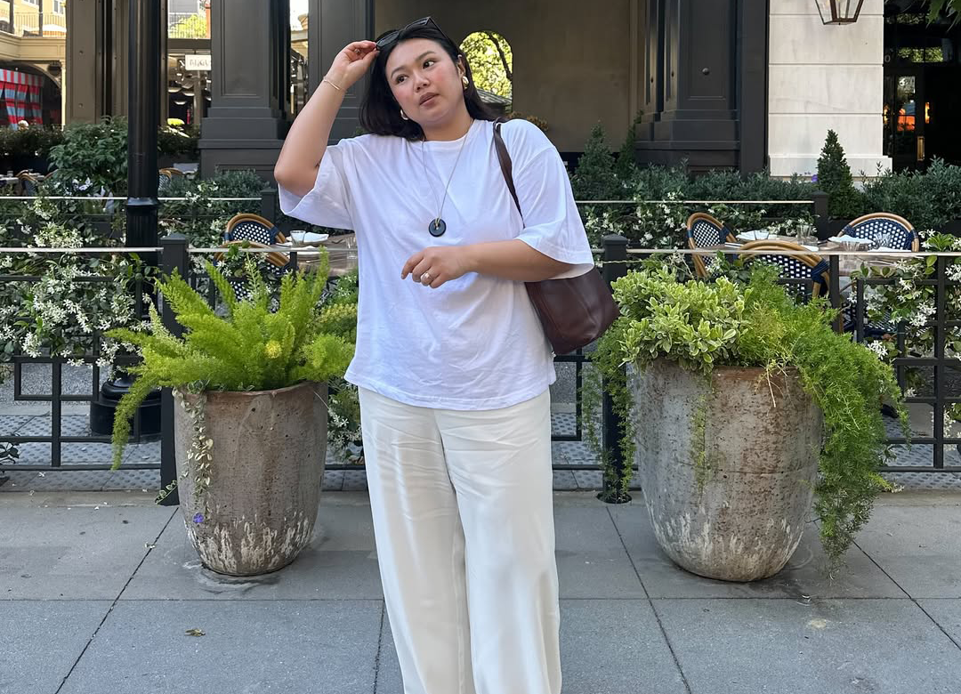 An influencer wearing a top and pants.