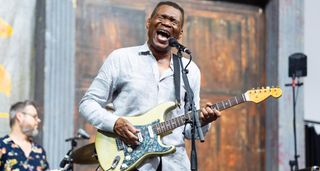 Robert Cray on the mic, playing a Strat, at the 2024 New Orleans Jazz &amp; Heritage Festival