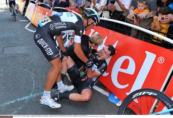 Mark Cavendish is comforted after his crash